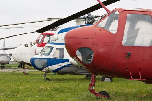 Soviet helicopters on airfield against green grass background