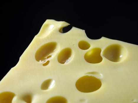 piece of cheese over black