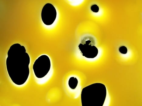 holes in cheese over black