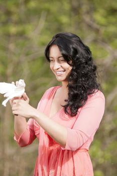 Romantic girl with a white dove in his hand