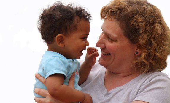 caucasian mother with mixed race child sharing a smile and happiness together