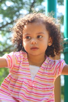 beautiful biracial little girl playing 