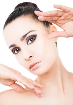 Portrait of beautiful woman with hands raised next to face