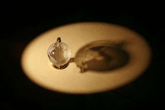 a glass globe in dramatic lighting............