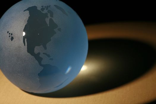 a glass globe in dramatic lighting............