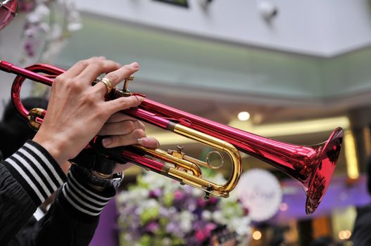 A musician is playing his trumpet 