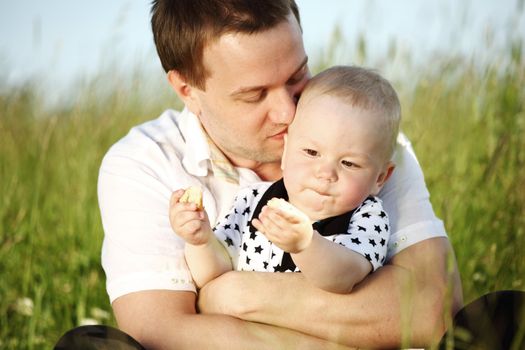 father and son in the grass
