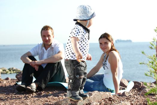 picnic of happy family near sea