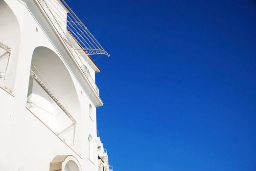 Mediterranean view with a white building on a blue sky