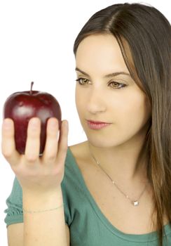 Young female model observing intense a big red apple