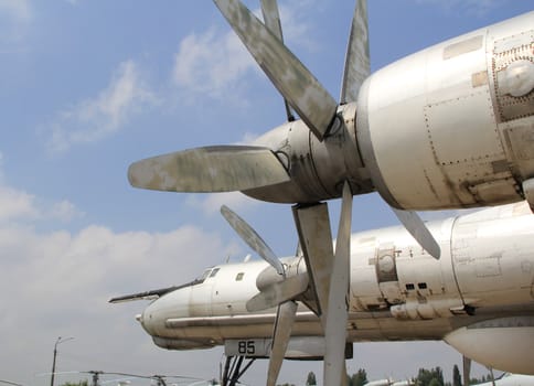 Strategic bomber propeller engine  against  cloudy sky background