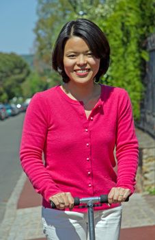 active and smiling woman in scooter