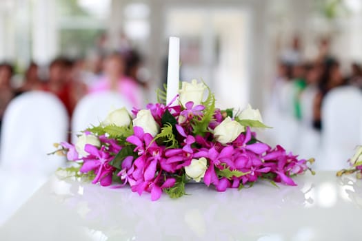 Candle burning during a wedding ceremony inside a church.