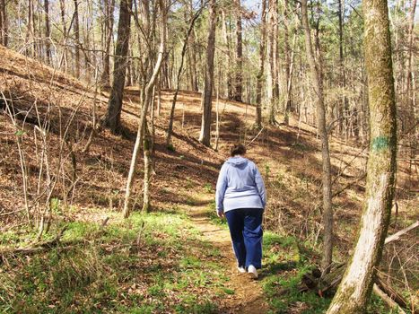 A woman hiking in the  woodsof Southeast  Texas