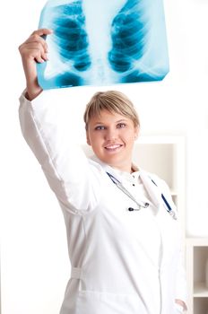 woman doctor looks at x-ray film, smile