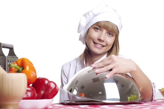 beautiful cook woman hold a metal dish with cooked food