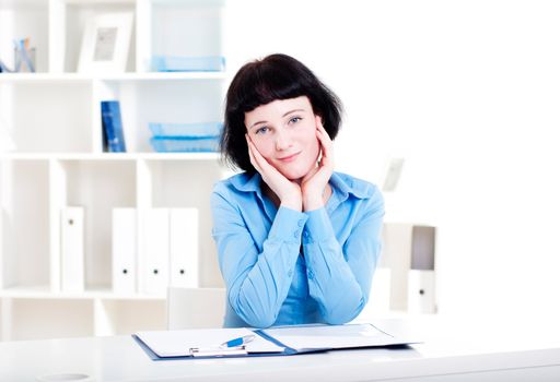 Portrait of a business woman in the office doing some paperwork