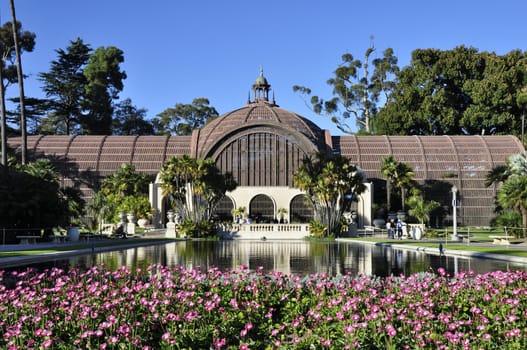 Colorful flowers frame this view of the Botanical Building in San Diego's Balboa Park.