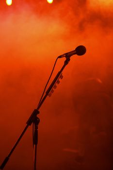 people at celebrating on an open-air.....microphone on a stage at a concert.....