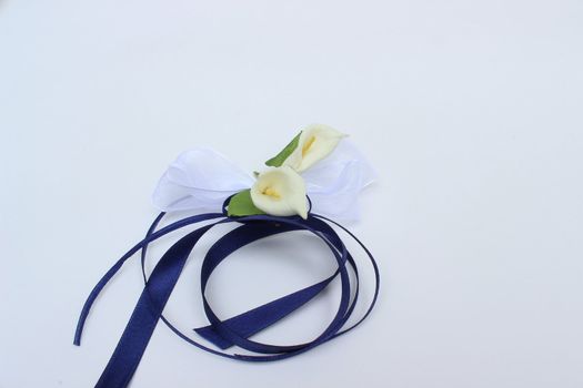 beautiful decorative flowers with blue ribbon on white background