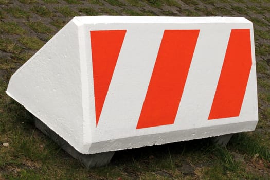 warning symbol on big concrete block