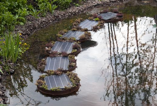 modern solar cells in garden used for the energy delivering for the water pump