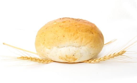 bread and wheat on a white background