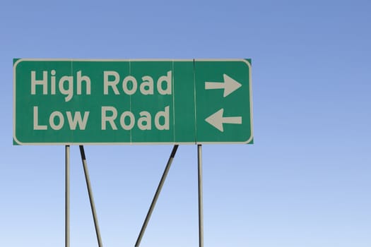 Green road sign with a blue sky gradient background.