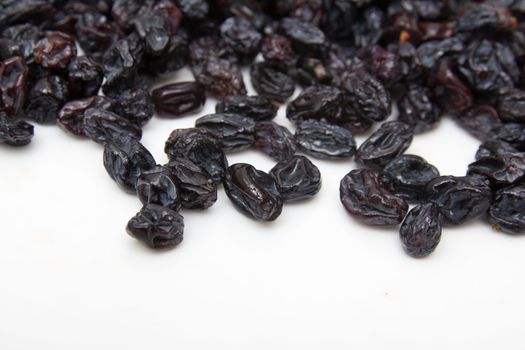 black raisins on a white background