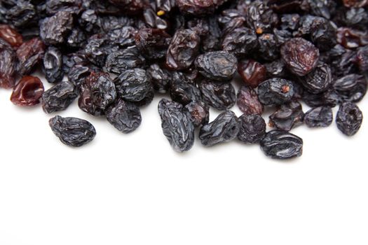 black raisins on a white background