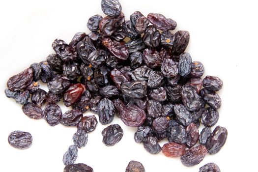 black raisins on a white background