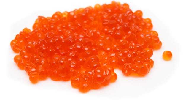 Red salmon caviar heap isolated on white 