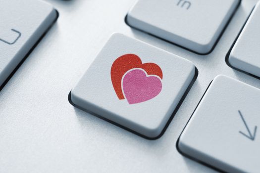 Online love button on the keyboard. Toned Image.