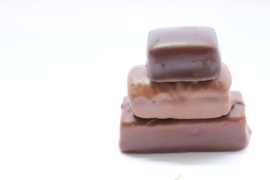 Chocolate candy bars stacked on top of each other.