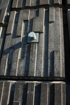 A section of an engineered precast retaining wall with a metal pin casing.