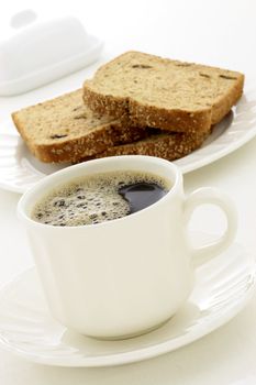 delicious breakfast with fresh hot coffee, butter and whole grain bread.