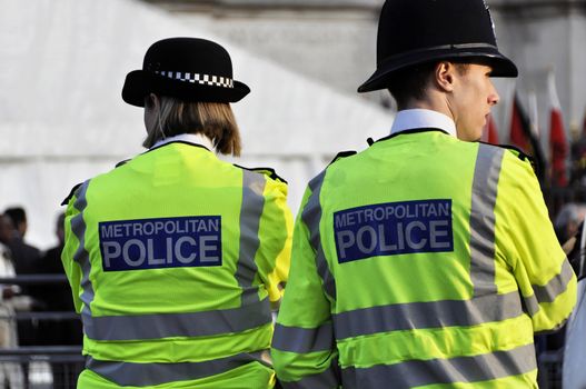 A police woman and a policeman wearing visibility jacket