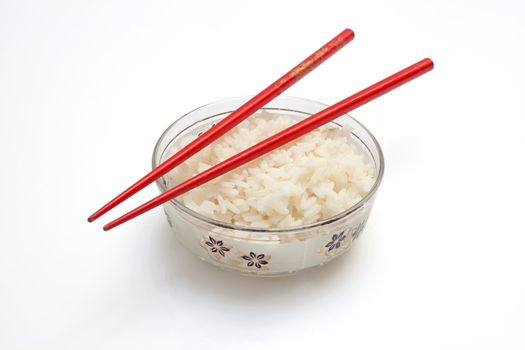 Boiled rice with butter on a white isolated background with chopsticks