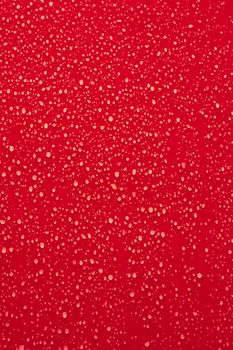 Water droplets on a red surface