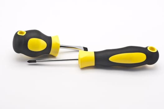 Two screwdrivers on a light background .