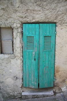 Frontdoor of a house in the Provence with wooden shutters