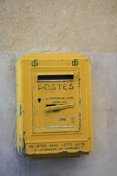 An old yellow french postbox in the Provence