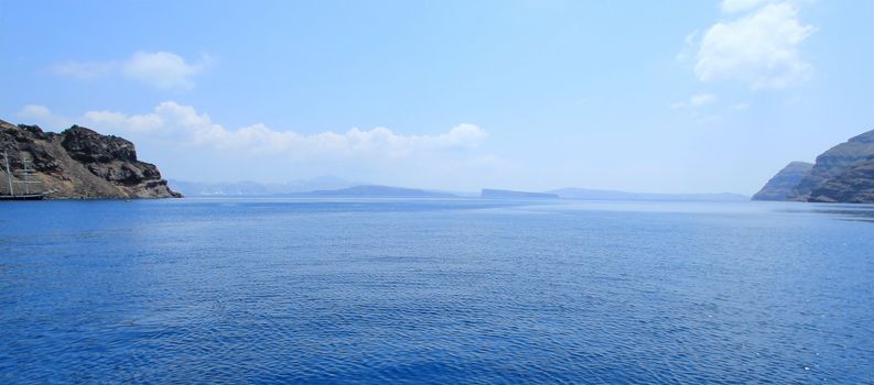 Panoramic view of aegean sea in the cyclades and the volcano from Thirassia island, Greece