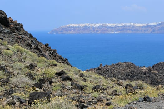 View of Oia village on the cliff from the volcano at Santorini, Greece