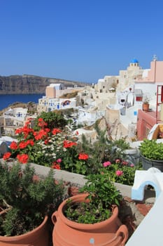 View on the caldera with a blue dome of orthodox churche in Oia, Santorini island, Greece