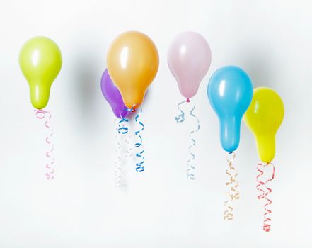 colorful floating balloons. Holiday Decorations on a light background