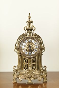 Antique bronze shelf clock with ornate decoration