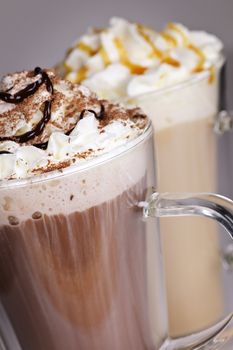 Hot chocolate and coffee latte beverages with whipped cream