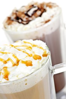 Hot chocolate and coffee latte beverages with whipped cream