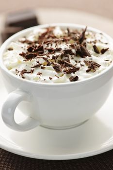 Cup of hot cocoa with shaved chocolate and whipped cream